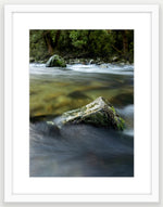 Milford Track, river rocks in the clear wilderness waters of a moody Clinton River, Fiordland, New Zealand.