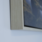 Close-up of a wooden float frame of canvas print corner on a white wall (NZ/AUS colour) 