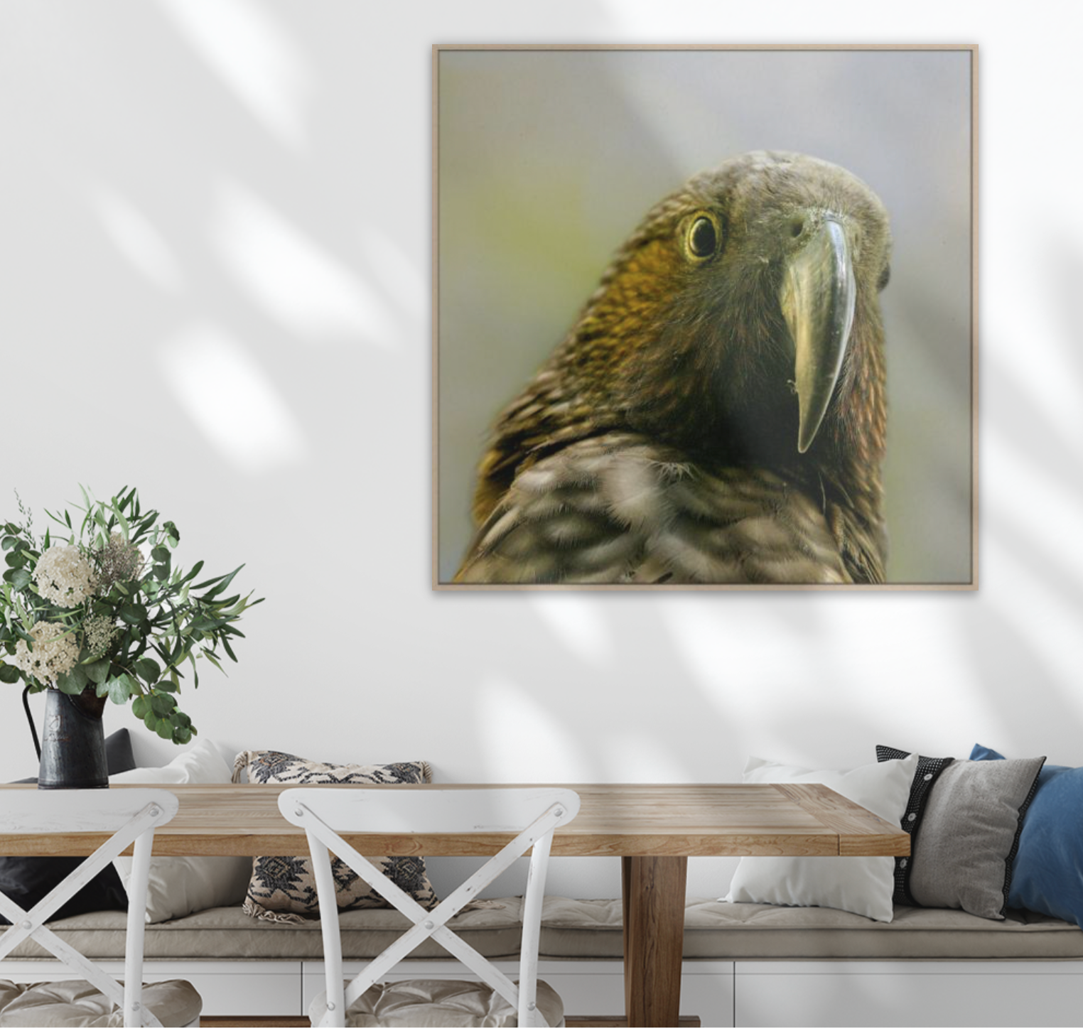 Framed artwork of a Kaka - native parrot on a wall above a dining table with a white chair.
XL Square wall art  