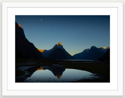 White wood frame  (594 x 420mm print, 720 × 550mm frame) Mitre te atakura Mitre Peak dressed in her red tips of dawn, te ata kura, on a rare and beautifully clear, still, morning. Milford Sound New Zealand. A2 size and A3 size