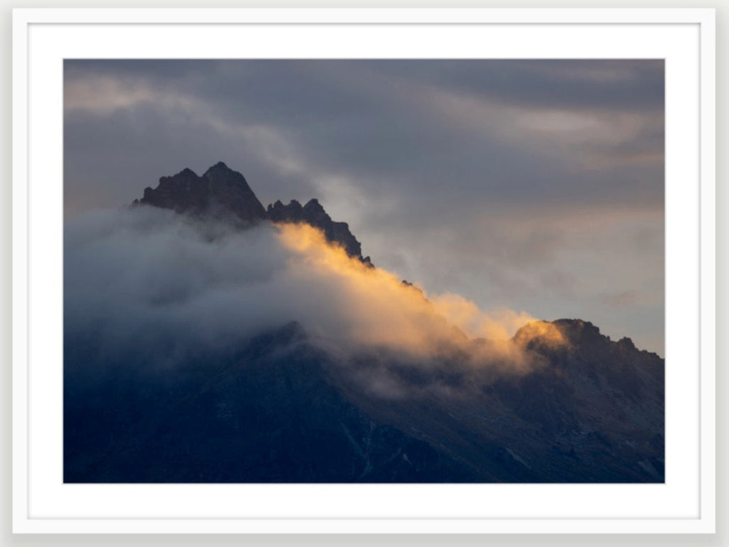 Walter Peak sunbeam is Queenstown's Walter Peak that can be seen from all over Queenstown. Cloudy sunset on Mountain top Lake Wakatipu, New Zealand. A1 size