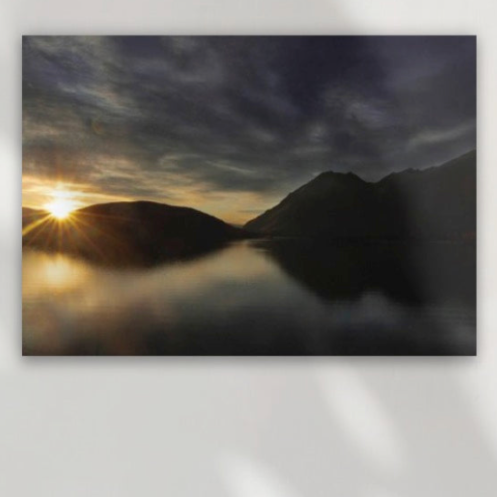 Sun rises over Lake Wanaka at dawn. A rich dark gold and deep blue black image. Large size A1 canvas wall art for living rooms; or choose premium framed wall art in 3 sizes.